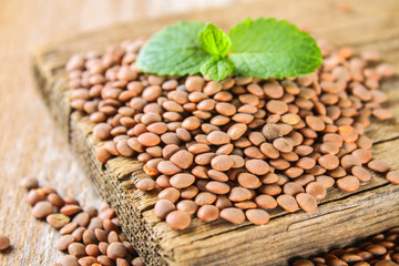 Raw red lentils on a wooden board. Superfood.
