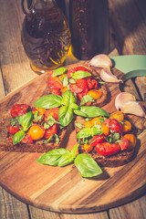 Bruschetta with tomatoes, herbs and oil on toasted garlic bread