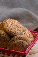 homemade oat cookies with sunflower seeds in basket on wooden table