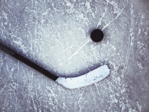 hockey puck and stick on the ice texture background