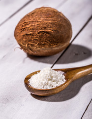 Coconut flakes in a shell on a blue background