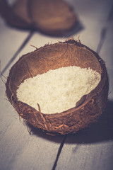 Coconut flakes in a shell on a blue background
