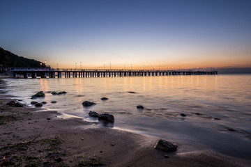 Obraz premium Amazing sunrise on the pier at the seaside. Gdynia Orlowo, Poland