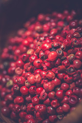 Pink pepper pile on wooden desk