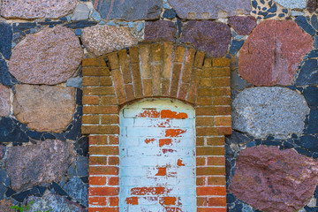 old wall of red brick and natural stone