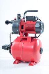 Red surface water pump. White background