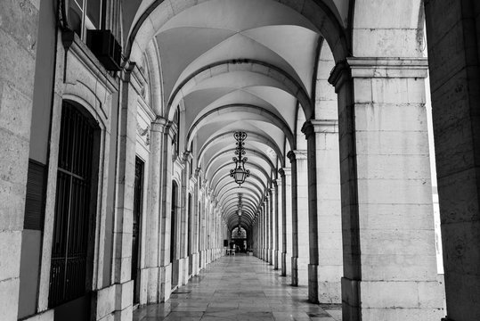 typical covered walkway, the portico of placa do comercio, lisbon,black and white