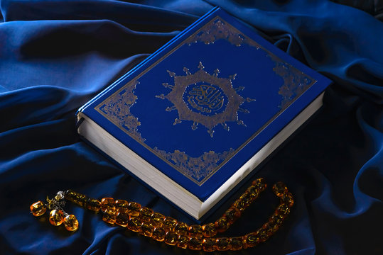 Holy islamic book Koran on the draped table with a rosary. Ramadan Kareem beautiful poster, banner, postcard for the celebration of the festival of the Muslim community