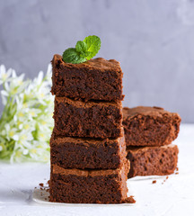a pile of square slices of baked brownie pie