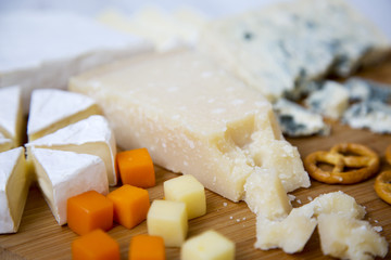 Tasty cheese on wooden board. Closeup
