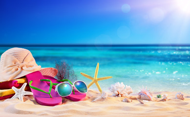 Fototapeta na wymiar Beach Accessories With Seashells On Seashore - Summer Holidays 