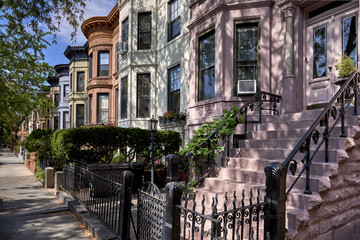 Fototapeta na wymiar a row of brownstone buildings and stoops in an iconic neighborhood of Manhattan, New York City.