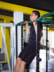 man doing pull ups on the horizontal bar