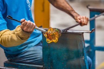 Pocos de Caldas, Minas Gerias/Brazil. Man shapping a crystal glass handicraft piece