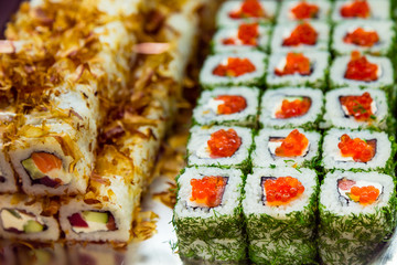 Rolls in the window in the sushi bar. Traditional Japanese food to takeaway. Organic natural products. Seafood. Serving delicacies