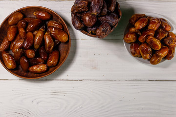 Dried dates fruit on white wooden table. Top view