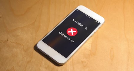 A cellular telephone on a desk rings with a phone call from a caller with no caller ID. The call is ignored. Phone number and screen are fictional.	 	