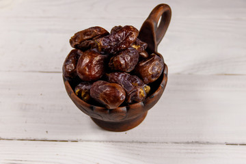 Dried dates fruit on white wooden table