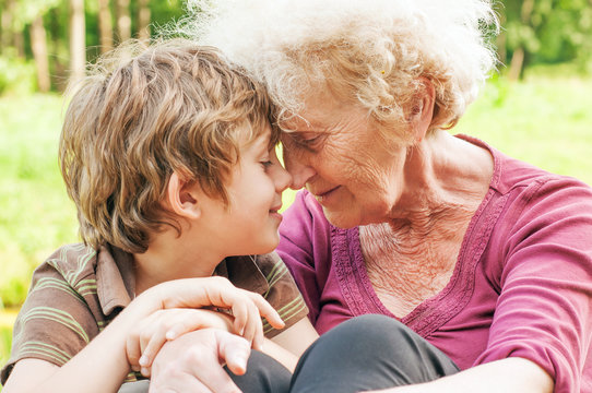 Happy grandmother with grandson together face to face