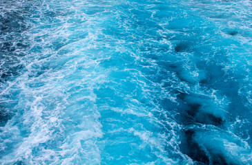 Sea water foam - ship tail. Tropical islands travel by ferry. Water texture. Cruiseliner seawater trail.