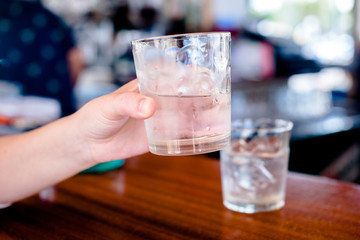 The girl holds a glass of Malibu rum in her hand