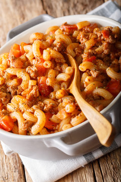 American goulash made from pasta with tomatoes, spices and ground beef close-up. vertical