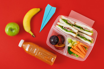 Healthy school lunch boxes sandwich vegetables juice top view