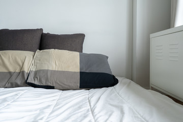 sunlight Bed maid-up with clean white pillows and bed  in the bedroom.