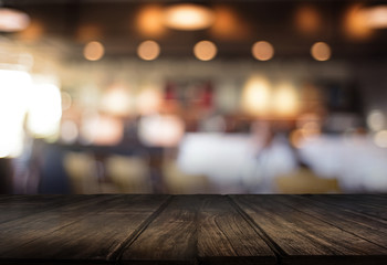 Wooden board empty table  cafe, coffee shop, bar blurred background can be used for display or montage your products and Mock up
