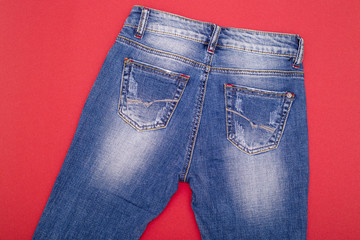 Shabby jeans light blue on a red background