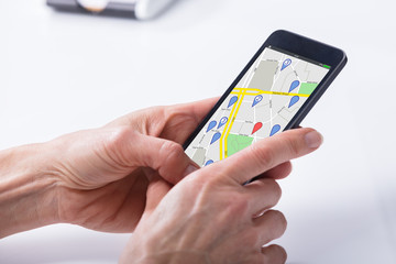 Person Using GPS Navigation Map On Mobile Phone