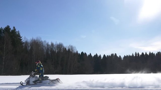 Snowmobile moving on the field