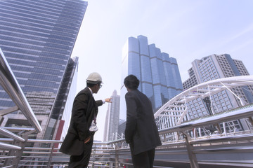 Engineers talk about building project on site.Architects, engineers and consultants in meeting...