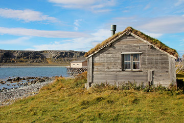 Fototapeta na wymiar Beautiful old house with grass roof in Hamningberg fishing village, northern Norway, Scandinavia Europe