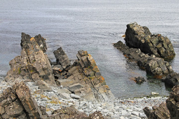 Folded rock formation in the sea, near Hamningberg, Norway, Scandinavia, Europe