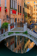 Fototapeta na wymiar Weathered building facade on a picturesque canal in Venice Italy