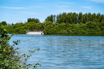 Passenger ferry floating along Marapendi Lagoon, in Barra da Tij.