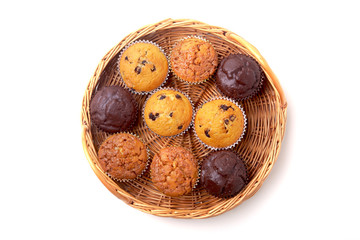 Wicker basket with assorted delicious homemade cupcakes with raisins and chocolate. Cupcakes. Top View. Copy space.