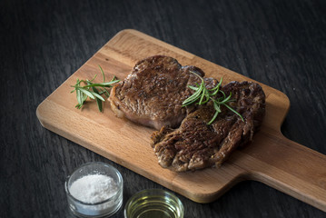 Grilled beef steak with rosemary, salt and pepper
