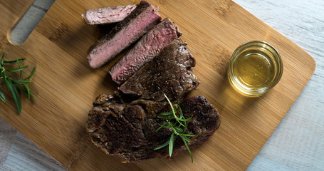 Grilled steak sliced on a cutting board. 