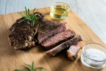 Grilled steak sliced on a cutting board. 