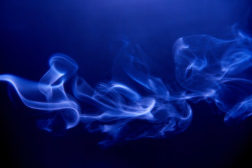 Blue clubs smoke on a black background, horizontal. Fluid effect.