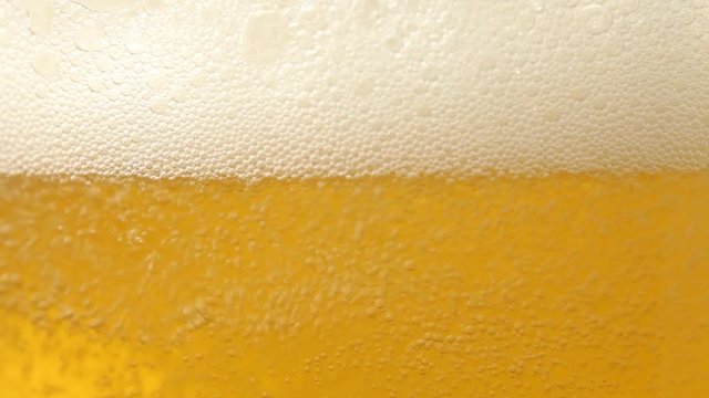 Close up of beer with bubbles. No sound. This file is cleaned and retouched.