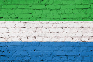 Texture of a flag of Sierra Leone on a brick wall.