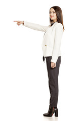 advertising young businesswoman in pants and suit standing on white background