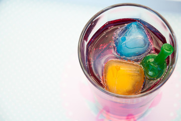 Summer cold drink  with colorful ice cubes