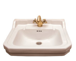 Ceramic beige sink with bronze tap, isolate.
