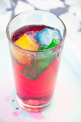 The glass with summer cold drink with cranberry and ice cubes