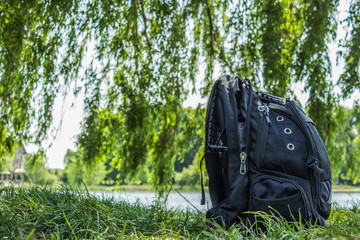 black backpack bag on nature background