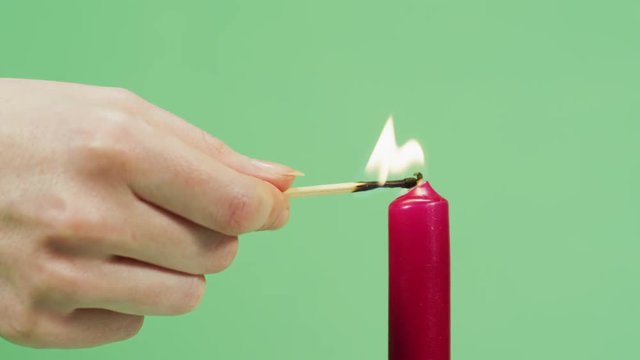 Close up of a hand firing a candle